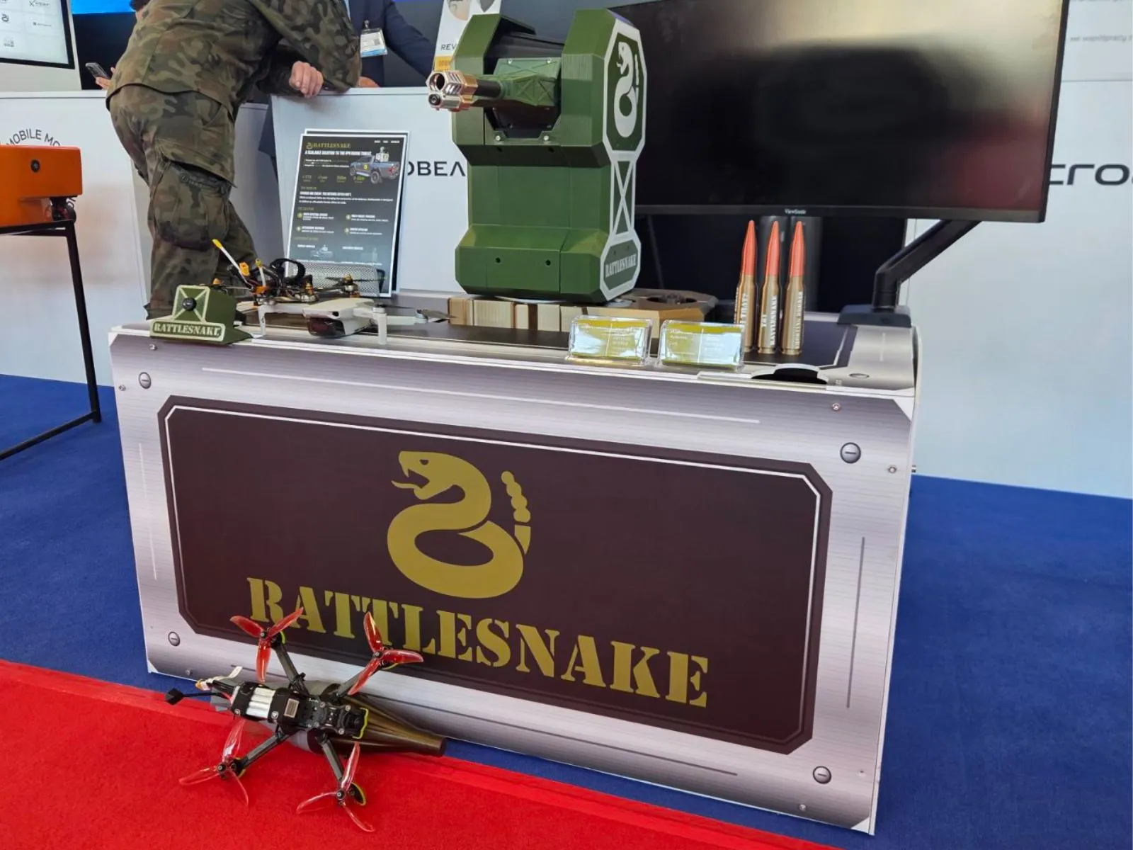 The Rattlesnake display at MSPO 2026, with the turret, an FPV drone, and ammunition on the stand